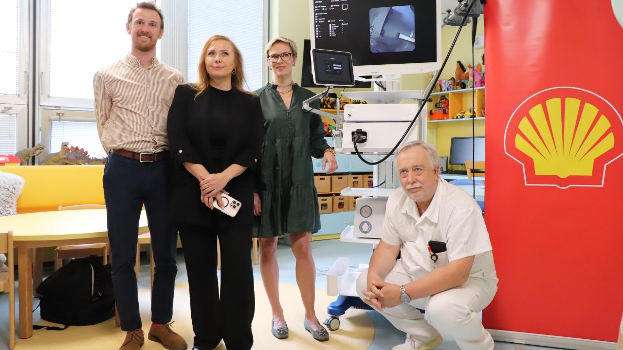 Team photo inside the clinic with shell logo