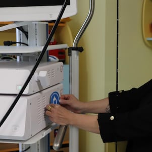 Women pasting sticker on medical equipment